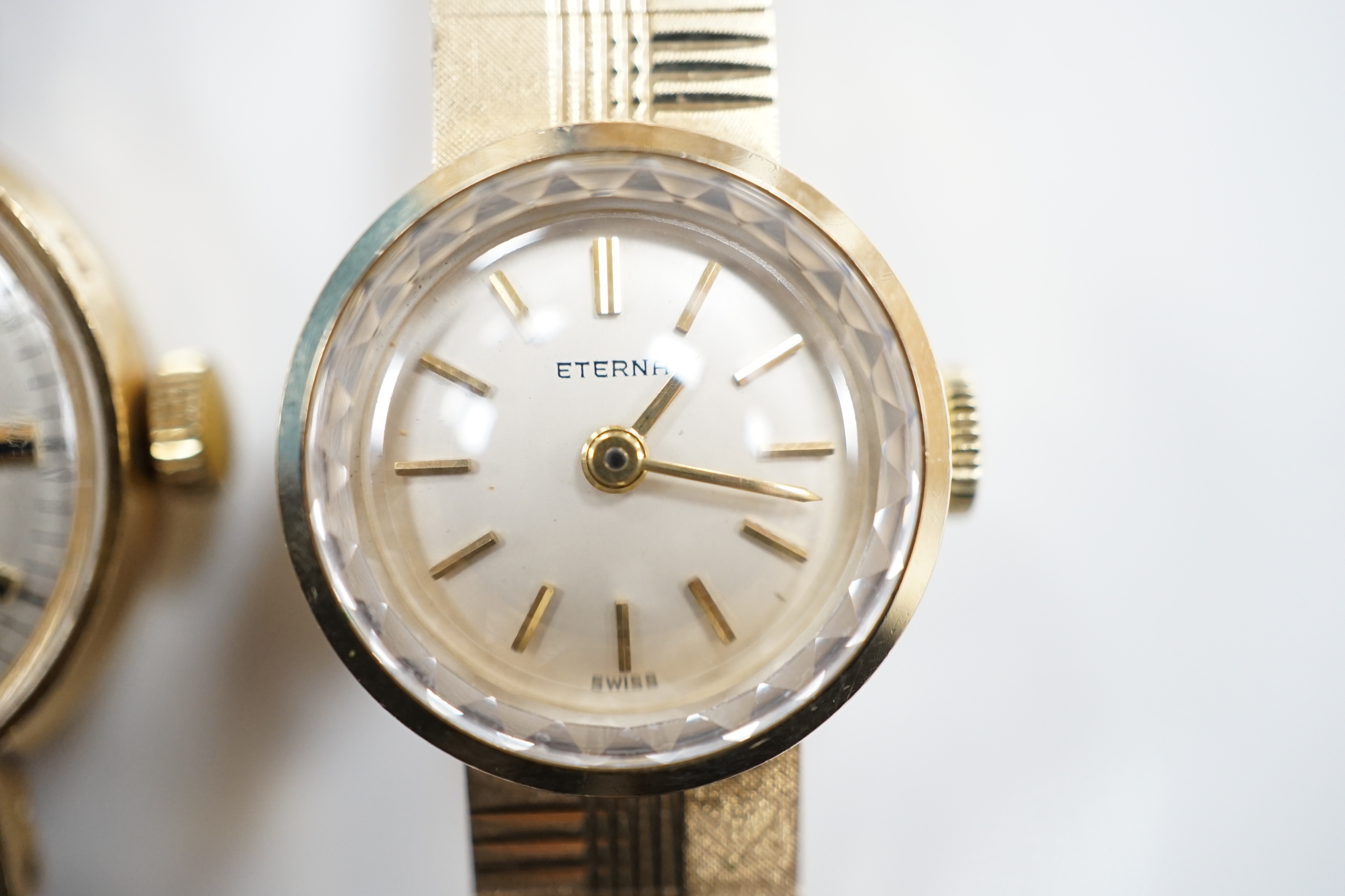 A lady's 9ct gold Eterna manual wind wrist watch, on a 9ct gold integral bracelet, overall 16.2cm, gross weight 23.7 grams, together with a lady's 9ct gold Rotary manual wind wrist watch, on a leather strap.